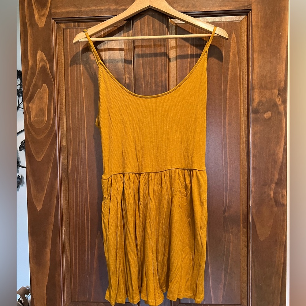 Gold romper with pockets.